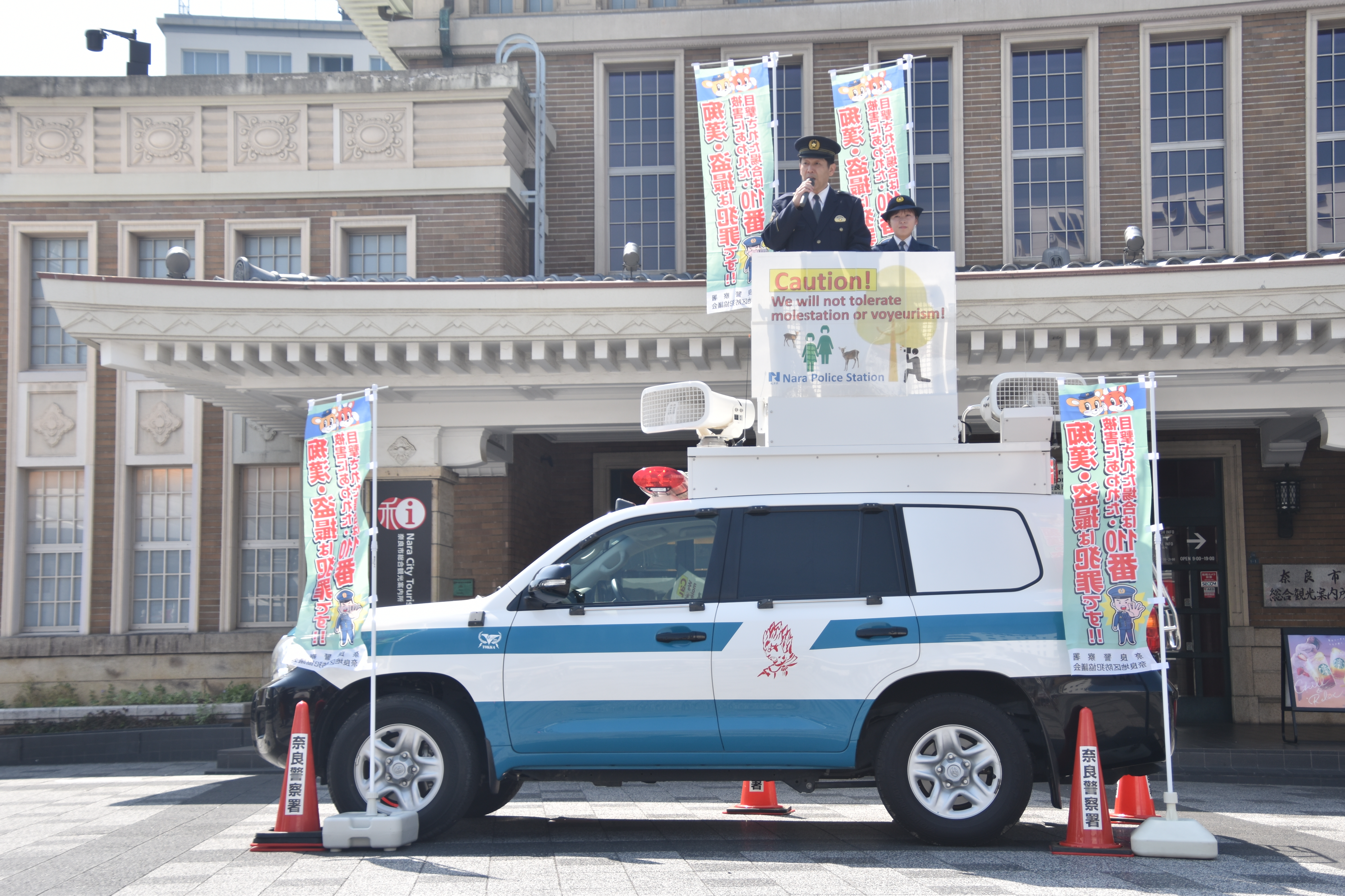 警察官が車の上でメロディパトロールをしている様子