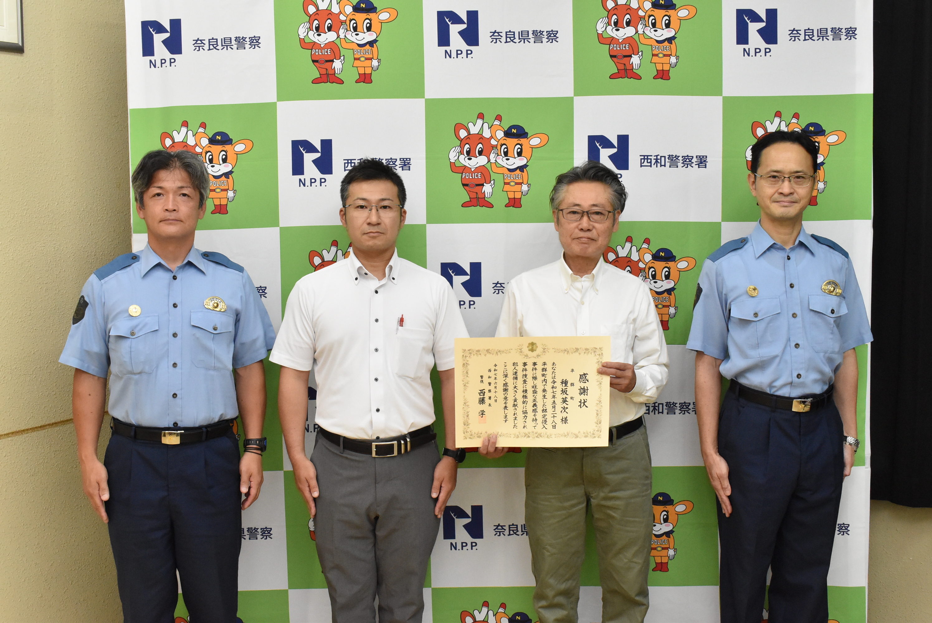 西和署長らと並び写真を撮る様子