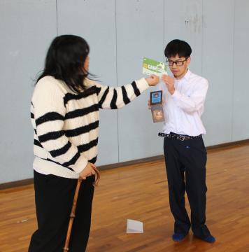 クレジットカードを渡す被害者役