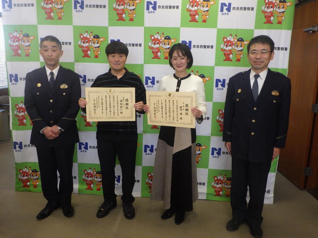 表彰状を持つ坂口様らの様子